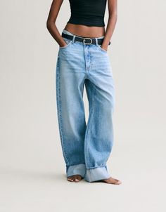 Loose-fitting baggy jeans with turn-up hems - Denim - Women | Bershka Chic Relaxed Fit Bottoms With Cuffed Ankles, Trendy Baggy Jeans With Belt Loops, Relaxed Fit Cotton Jeans With Rolled Hem, Chic Baggy Tapered Leg Jeans, Trendy Bottoms With Rolled Hem And Cuffed Ankles, Trendy Relaxed Fit Pants With Cuffed Ankles, Trendy Relaxed Fit Cropped Jeans With Belt Loops, Straight Leg Jeans With Rolled Hem, Spring Denim Blue Bottoms With Cuffed Ankles