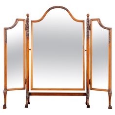 a large wooden mirror sitting on top of a table