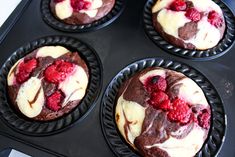 four chocolate raspberry cupcakes in a muffin tin