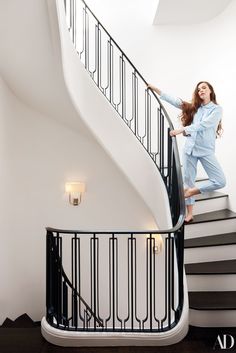 a woman standing on top of a stair case