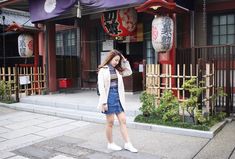 a woman standing in front of a building