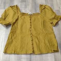 Brand New With Tags Mustard Yellow Madewell Blouse Beautiful Detail In The Sleeves With Buttons All Across The Front Beautiful Elastic Back For Comfortable Wear Size: Oo Brand: Madewell Gold Fitted Casual Blouse, Casual Mustard Cotton Blouse, Gold Fitted Top For Day Out, Fitted Gold Top For Day Out, Mustard Short Sleeve Casual Blouse, Mustard Casual Short Sleeve Blouse, Casual Mustard Short Sleeve Blouse, Mustard Short Sleeve Top For Day Out, Casual Gold Blouse For Day Out