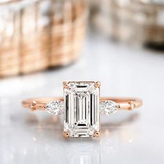 an emerald cut diamond ring with three side stones