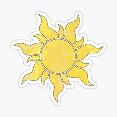 a yellow sun sticker sitting on top of a white surface, with the sun in the center