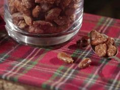 some nuts are in a glass bowl on a table