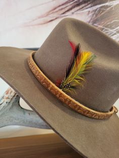 add instant cool to your favorite  felt or cowboy hat  1/2" inch wide Genuine  leather  hand tooled antique brass eyelets suede straps stained light brown/ beige  antique one size fits all ( 55 to 66 cm) thank you for supporting handmade! Feathers not included Ships with tracking and insurance Brown Leather Hat Bands For Hunting, Rustic Adjustable Felt Hat With Short Brim, Brown Curved Brim Top Hat For Ranch, Vintage Adjustable Felt Hat For Western-themed Events, Adjustable Brown Hats For Hunting, Rustic Adjustable Hat For Hunting, Western Style Brown Fedora With Flat Crown, Brown Concho Hat For Ranch, Western Brown Fedora With Flat Crown