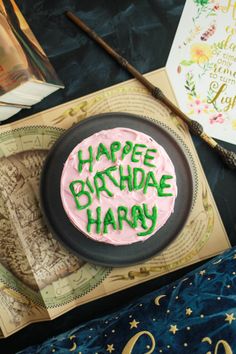 a harry potter birthday cake with the words happy birthday harry written on it in green frosting