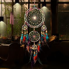 an image of a dream catcher on display in a store window with lights behind it