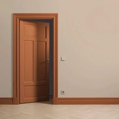 an open door is in the middle of a room with parquet floors and white walls