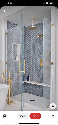 the bathroom is decorated in white and gold with herringbone tile on the shower wall