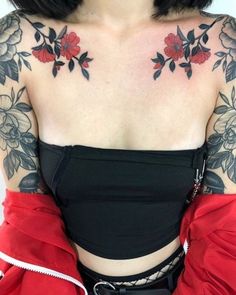 a woman with black and red tattoos on her chest