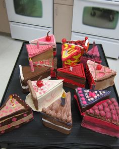 a table topped with lots of different types of cakes