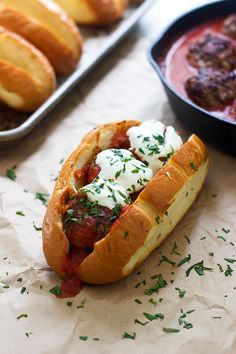 a meatball sub sandwich with sour cream on top