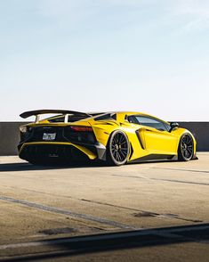 a yellow sports car parked on the tarmac