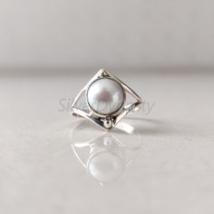 Stone : Pearl Metal : 925 Sterling Silver Stone Size : 8mm ( Can be customized as per your need) Shape : Round Band Size : 2mm Ships worldwide from India 925 stamped Handmade Item STYLE STATEMENT Be it ethnic or casual wear, this ring is sure to add style to your look. Match it with any attire and stay trending at all times. CUSTOMIZATION We welcome customization.Change in gemstone or design as per your need can be done. The stone size can also be changed as per your need. We are just a message Silver Sterling Pearl Ring, Silver Stackable Open Pearl Ring, Sterling Silver Open Pearl Ring With Polished Finish, Silver Pearl Promise Ring With Round Band, Minimalist Silver Pearl Ring With Polished Finish, Sterling Silver Pearl Promise Ring, Sterling Silver Pearl Ring Gift, Silver Solitaire Pearl Ring, Silver Stackable Pearl Ring As Gift