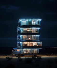 a car parked in front of a tall building with lights on it's sides