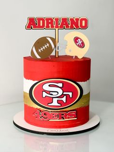 a birthday cake with a football and helmet topper on it's tiers