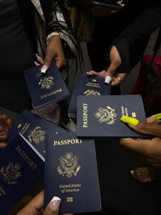 several people holding up their passport cards