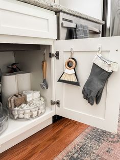 an open cabinet with gloves and other items in it