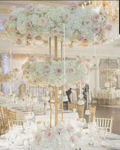 the centerpieces in this wedding reception are filled with white and pink flowers, which is