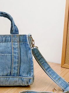 a blue purse sitting on top of a wooden floor