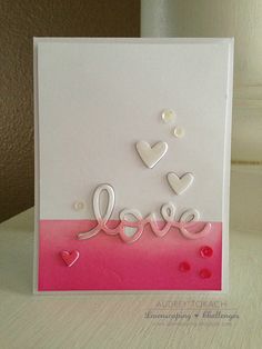 a handmade card with hearts and the word love written in white letters on it