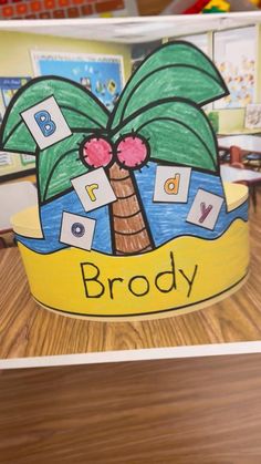 a paper crown with the words broddy written on it and a palm tree in front