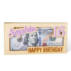 a wooden frame with the words happy birthday written on it and money bills in front