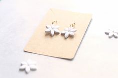 These are the perfect earrings for the bride with a minimalist taste. So light weight. They won't get in the way on your special day. I use Sculpey Premo clay and ear wire is Hypoallergenic, Gold plated Stainless Steel and nickel free! These are made to order but I usually have 3 ready to go so that they ship as soon as possible! Elegant Earrings White Dainty Flower Earrings Floral Earrings Minimalist Earrings Bridal Flower Earrings White Statement Earrings Daisy Care: Do not wet polymer clay ea Delicate White Earrings For Everyday Wear, White Flower Charm Earrings For Everyday, White Drop Earrings For Bridesmaid Gift, Minimalist White Flower Earrings For Gift, Delicate White Earrings For Wedding Gift, Minimalist Flower-shaped Earrings For Anniversary, Simple White Drop Earrings, Minimalist Everyday Earrings With Flower Charm, Everyday Minimalist Earrings With Flower Charm