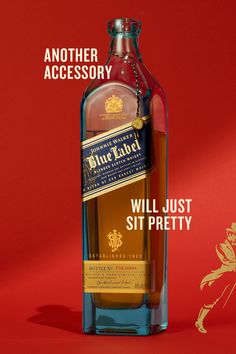 a bottle of blue label whisky sitting on top of a red background with the caption, come with a kick