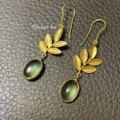 Thank you for coming in!  Spectacular 18K solid yellow gold earrings with leaf design and old stock prehnite bezels!  Looks much much nicer in person with gem glow! You'll get the pair of earrings you see! WEIGHT: 12.35 carats DIMENSION: 1.7 Inch Total Length. prehnite bezel 8.5mmx10.8mm.  MATERIAL: 18K Solid Yellow Gold,  Prehnite. Unique Gold Cabochon Earrings, Gold Flower Earrings With Czech Glass, Gold Pressed Flowers Dangle Earrings, Leaf Design Earrings, Nickel-free Gold Flower Earrings With Czech Glass, Nickel-free Gold Czech Glass Flower Earrings, Gold Flower-shaped Earrings With Czech Glass, Hobby Ideas, Flower Leaf