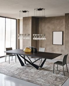 a modern dining room table with chairs and chandelier