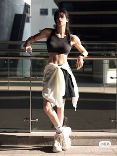 a woman is standing on the steps with her arms crossed and looking at the camera