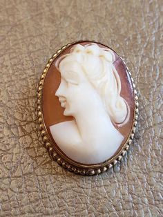 This is a vintage AMCO cameo brooch/pendant. It is oval and is stamped 1/20 14 K GF. The cameo measures just over .75 x a bit over 1 inch. Don't forget to stop in at my other Etsy shop... http://www.etsy.com/shop/xtdesigns. Follow me on Twitter at... MyYiayiaHadThat@MyYiayiaHadThat. If you have a wish list or are looking for something specific, please ask. I may have exactly what you are looking for. As always please convo me with any questions or concerns regarding this item or with any interna Formal Cameo Brooch, Luxury Classic Cameo Brooches, Collectible Oval Cameo Brooches, Formal Cameo Pendant Brooch, Collectible Cameo Pendant Brooches, Cameo Brooch, Purple Velvet, Gold Filled, Give It To Me