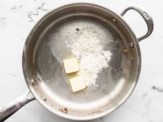 two cubes of butter sit in a saucepan