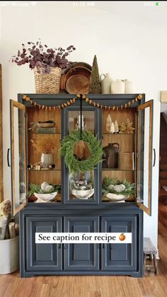 an old china cabinet is decorated for christmas