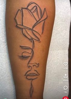 a woman's leg with a rose tattoo on the side of her thigh,