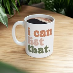 a white coffee mug with the words i can list that on it sitting on a wooden table