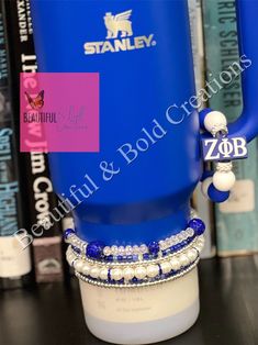 a blue container with some beads on it sitting on a table next to bookshelves