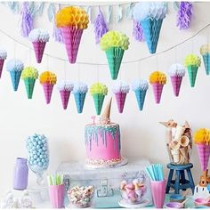 a table topped with cake and cupcakes covered in icing