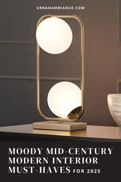 the modern table lamp is shown on top of a black counter with text reading, mody mid - century modern interior must haves for 205