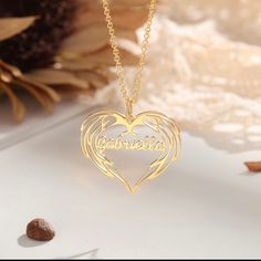 Keep their names tucked in this elegant heart that is shaped like Angel Wings. Unique name necklace made only with high quality materials. Choose between Gold plated, Rose Gold, or Silver to compliment any outfit. Part of our new collection, this necklace is ready to be gifted. Customized Heart Pendant Necklace For Wedding, Elegant Double Heart Name Necklace For Personalized Gift, Customized Heart Necklace For Wedding, Elegant Engraved Heart Necklace For Mother's Day, Gold Heart Necklace With Name For Mom, Elegant Heart Necklace With Name, Personalized Heart-shaped Name Necklace, Personalized Heart Name Necklace, Personalized Heart Name Necklace For Wedding