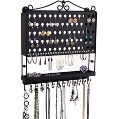 a wall mounted jewelry rack with lots of earrings