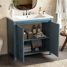 a bathroom with a blue cabinet and sink