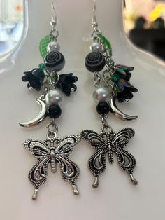 🌙✨Whimsigoth dangle earrings  Moon, butterfly charms, black bellflower beads Whimsical Dangle Jewelry With Moon Charm, Silver Mystical Dangle Earrings, Purple Bohemian Jewelry With Moon Charm, Mystical Moon Charm Dangle Earrings, Bohemian Dangle Jewelry With Butterfly Charm, Halloween Jewelry, Butterfly Earrings, Goth Fashion, Czech Glass Beads