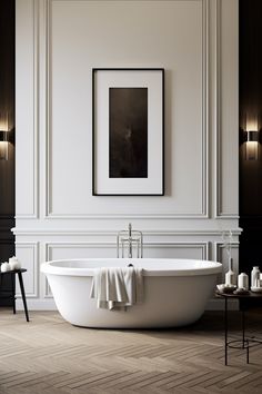 a white bath tub sitting in a bathroom next to two candles