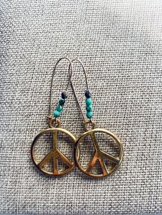 Gold with teal Czech glass beads peace earrings.  Kidney shaped ear wire. Peace sign measures(Approx):  Just under1" Wire Peace Sign, Peace Earrings, Light Weight Jewelry, Lightweight Earrings, Small Earrings, Light Weight Earrings, Peace Sign, Czech Glass Beads, Ear Wire