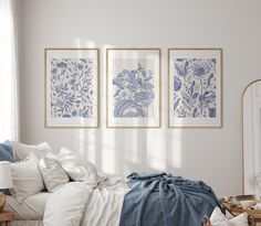 a bedroom with blue and white wall art above the bed