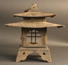 an old metal lantern with a bird on top