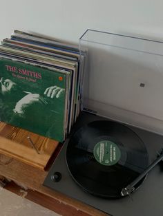 an old record player and some records on a table